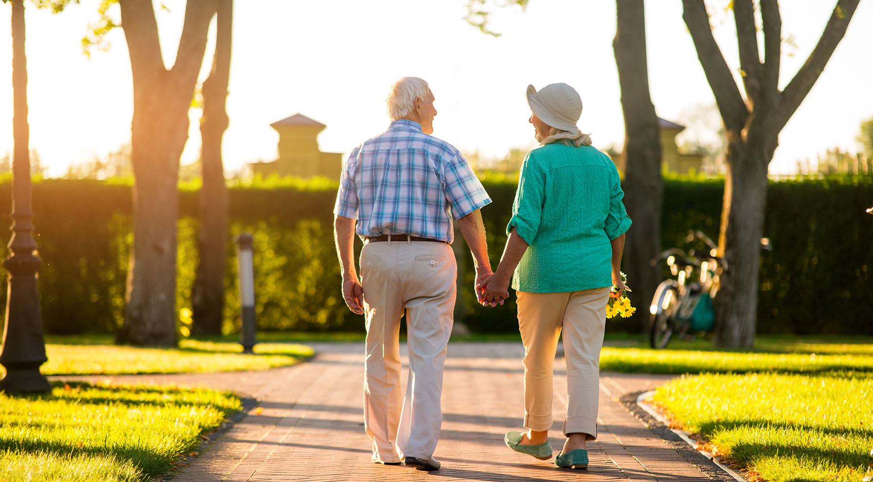 Elderly couple holding hands and walking 