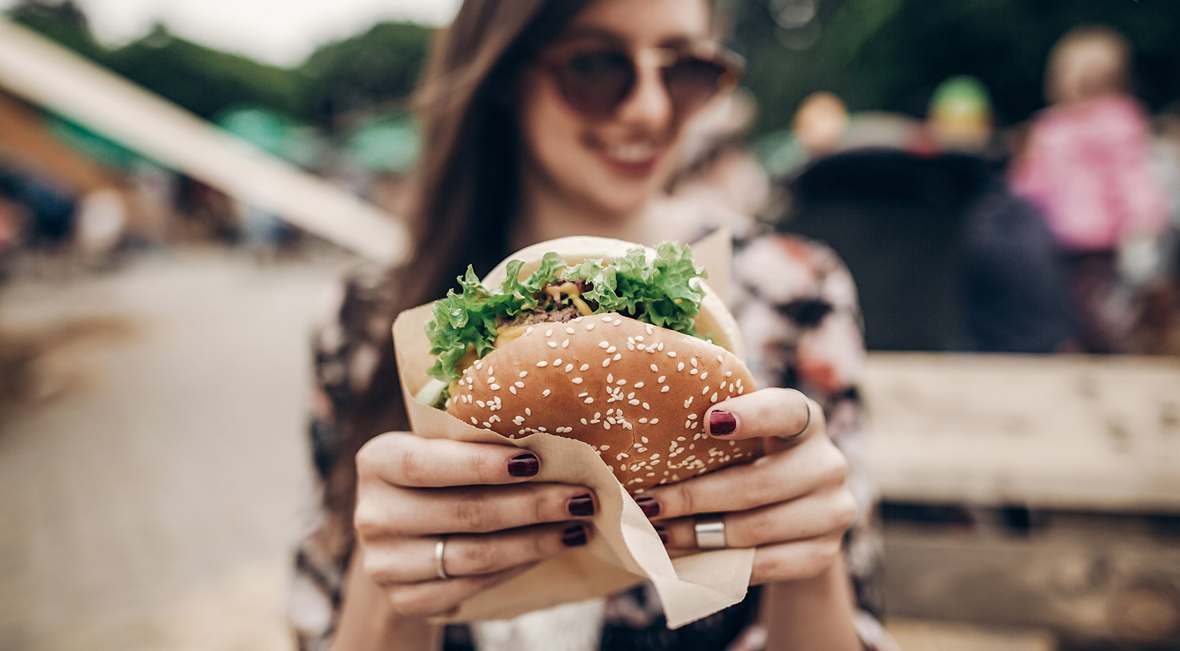 Woman holding a burger 